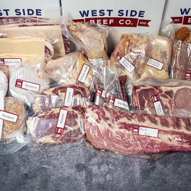 Assorted packaged meats, including burgers, ribs, chicken pieces, pork chops, sausage, and beef cuts, arranged in branded boxes.