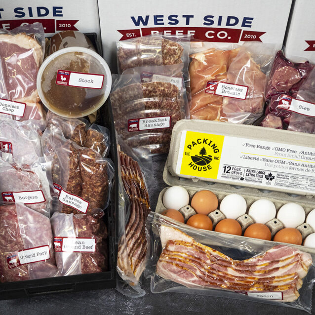 Assorted packaged meats, eggs, and bacon, including pork chops, sausages, chicken breasts, stew meat, and stock.