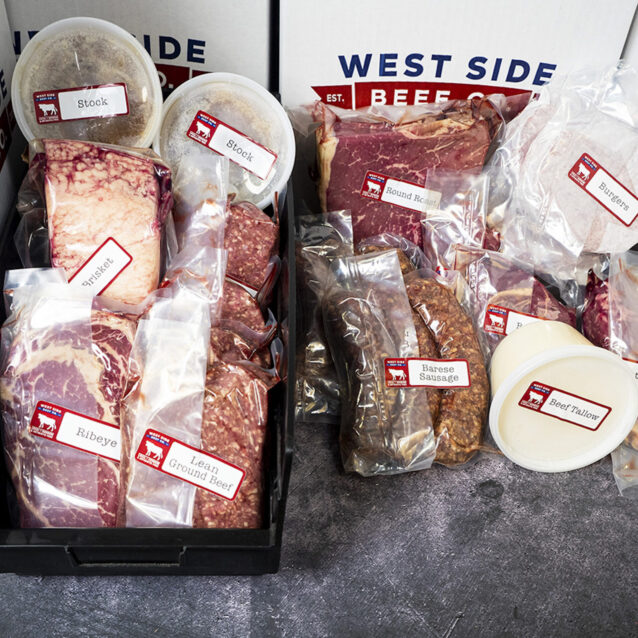 Assorted packaged beef products arranged in branded boxes and trays on a gray floor.