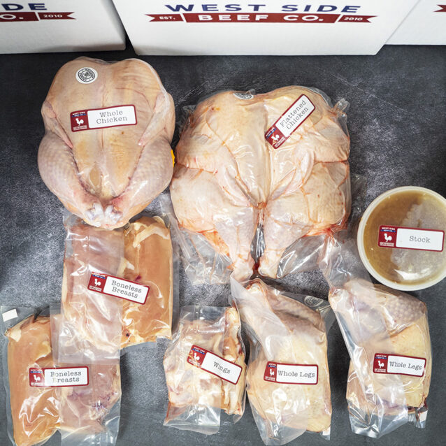 Assorted packaged chicken products, including whole chicken, boneless breasts, wings, legs, and stock, arranged in branded boxes.