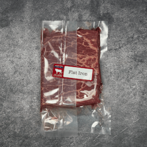 Flat iron steak vacuum-sealed in clear packaging with label.