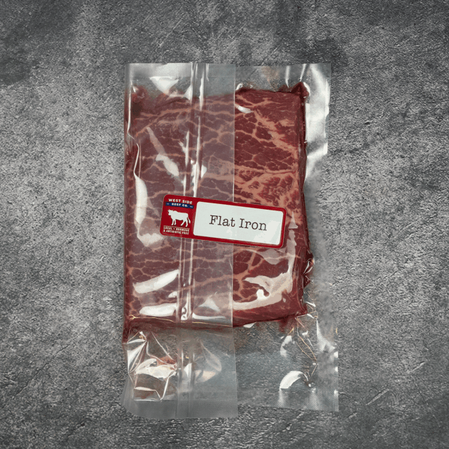 Flat iron steak vacuum-sealed in clear packaging with label.