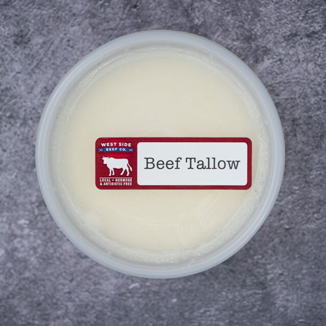 Beef tallow in a sealed plastic container on a textured surface.