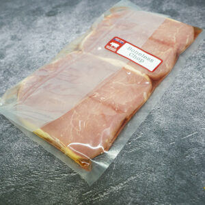 Single vacuum-sealed pack of boneless pork chops on a gray surface.