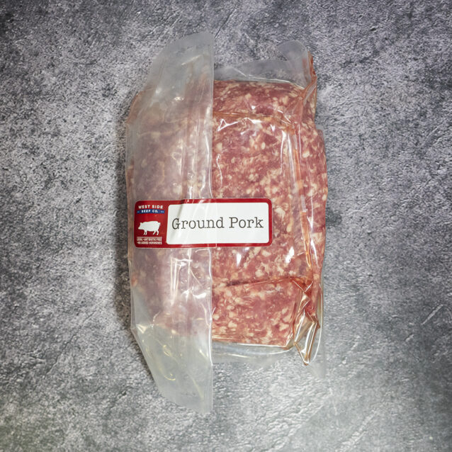 Vacuum-sealed ground pork with a "Ground Pork" label on a gray textured surface.