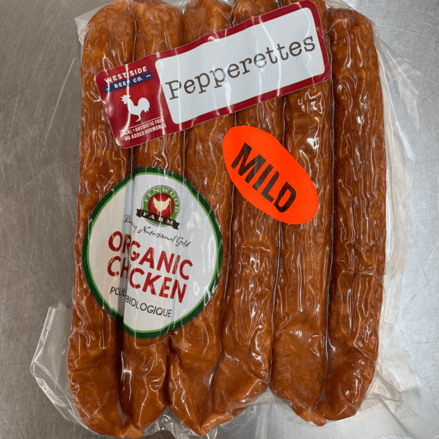 Vacuum-sealed pack of chicken pepperettes with "Pepperettes," "Organic Chicken," and "Mild" labels on a metal surface.