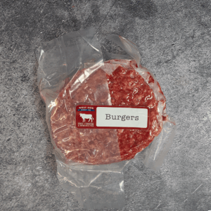 Vacuum-sealed beef burger patties, labeled and placed on a gray surface.