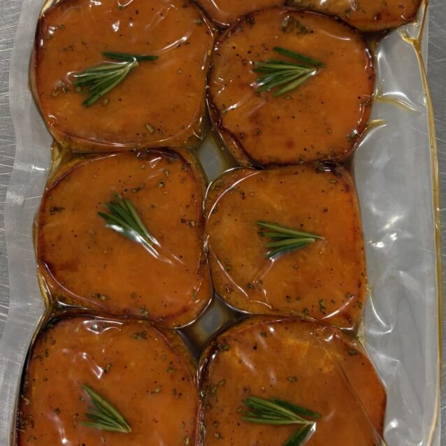 roast sweet potato coins in a vac bag with herbs on top